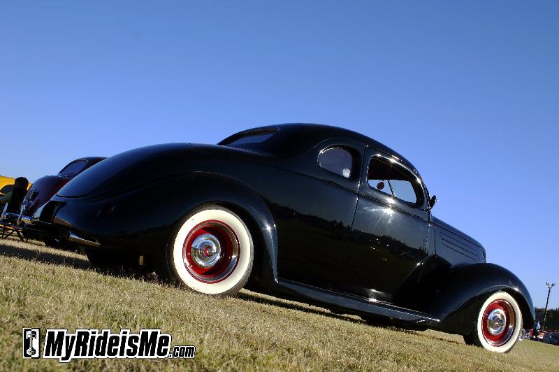 Slick black hot rod with wide white walls