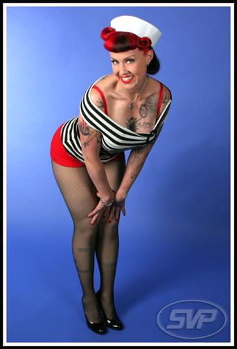 Pin Up Red Hair. With tattoos and bright red