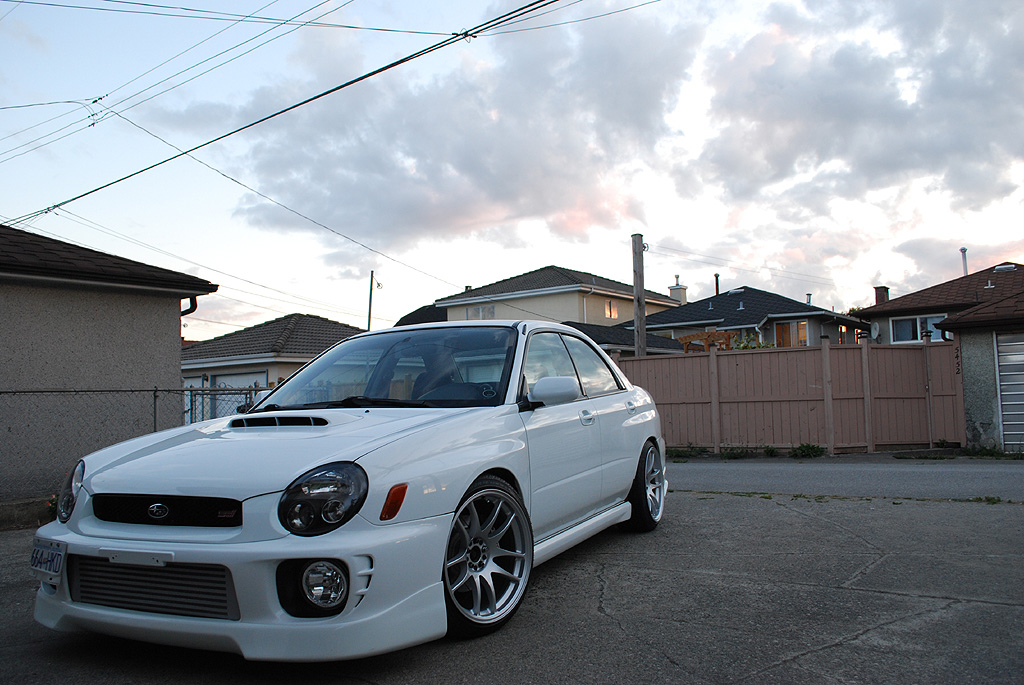 Bugeye Subaru WRX running aggressive fitment HellaFlush wheels