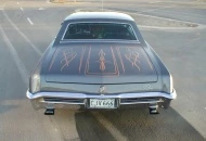 The trunk lid features a mixture of flamess, scallops and freehand by Frank Palmer.