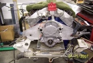 Motor on the engine stand, with a modified OEM crossmember attached to the attached front engine plate.